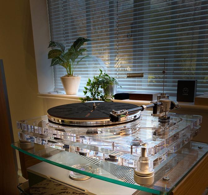 Vertere MG-1 MKII Magic Groove Turntable in the ripcaster showroom.  it's in front of a blind and there's a plant on the windowsill.