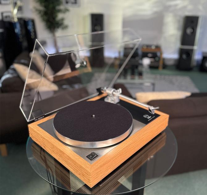 Linn Majik MM LP12 Fluted turntable in oak in the ripcaster showroom with sofas and speakers in the background along with other HiFi equipment