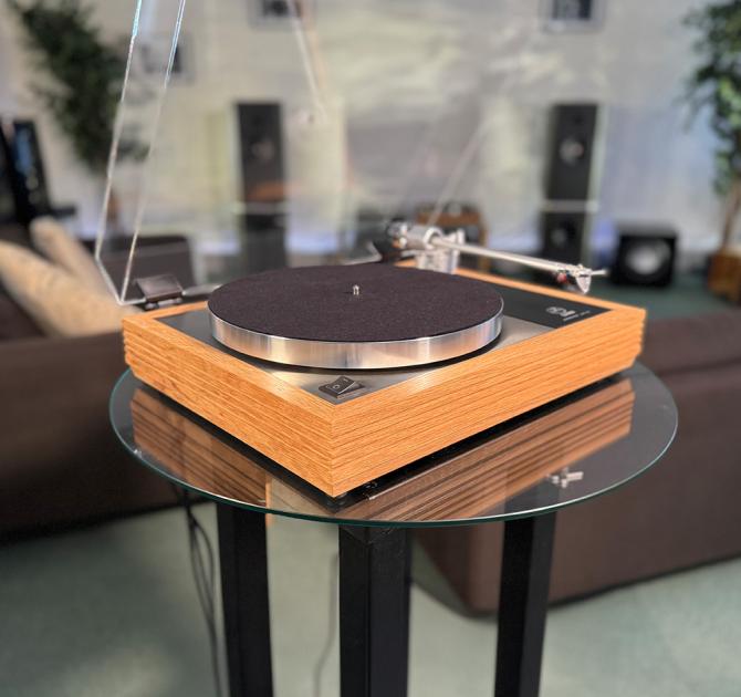 Linn Majik MM LP12 Fluted turntable in oak in the ripcaster showroom with sofas and speakers in the background along with other HiFi equipment