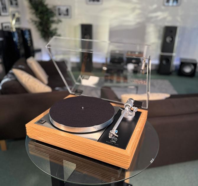 Linn Majik MM LP12 Fluted turntable in oak in the ripcaster showroom with sofas and speakers in the background along with other HiFi equipment