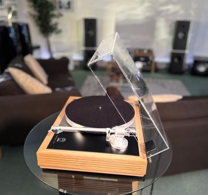 Linn Majik MM LP12 Fluted turntable in oak in the ripcaster showroom with sofas and speakers in the background along with other HiFi equipment