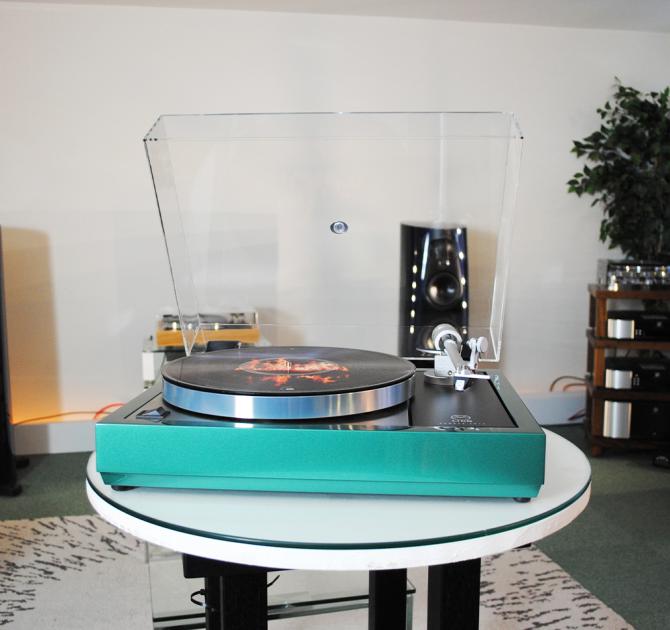 Linn Majik LP12 MC Turntable with a custom green plinth.  There are other pieces of HiFi kit in the background.