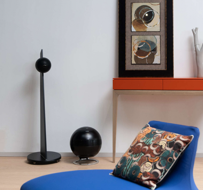 Cabasse Pearl SUB Loudspeaker in a living room with a blue chair in the foreground