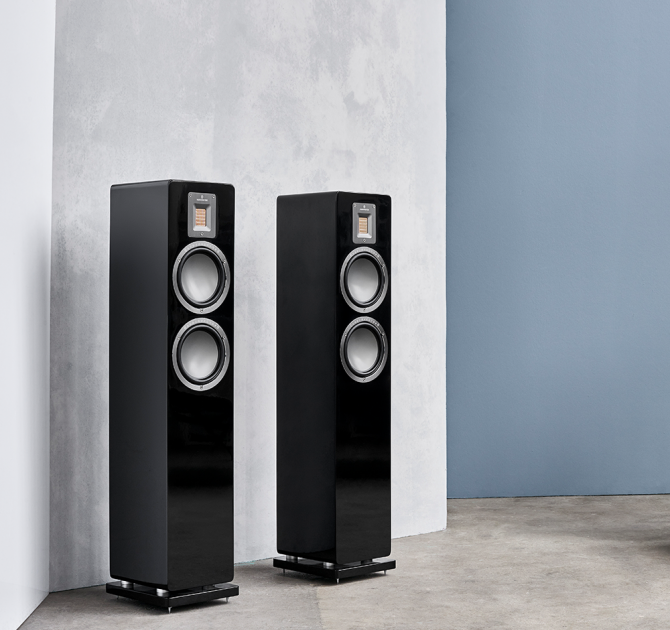 Audiovector QR3 pair in piano black against a grey wall