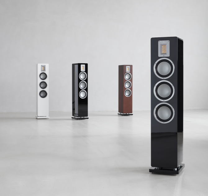 Audiovector QR5 in all colours.  Piano black in the foreground and three other QR5s in the background.