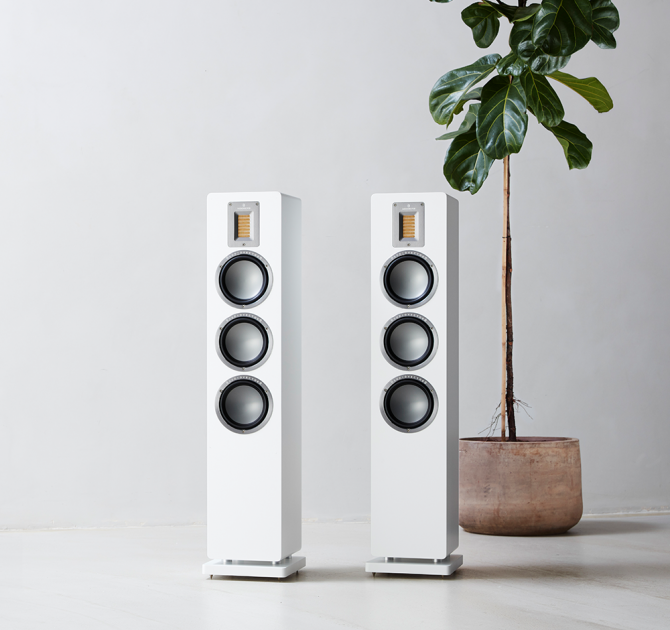 Audiovector QR5 pair in white next to a tall houseplant
