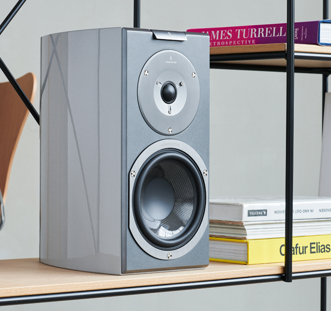 Audiovector R1 Signature in custom grey on a shelf beside some books