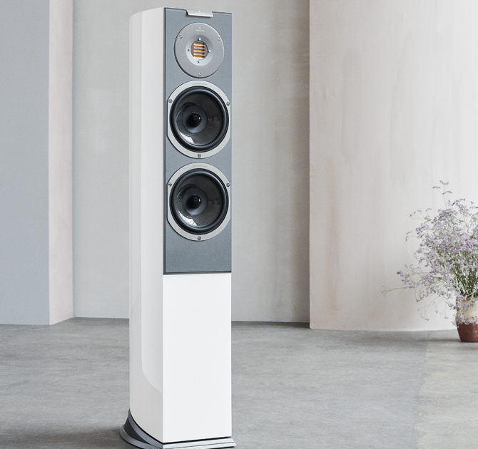 Audiovector R3 Arreté with a vase of flowers in the background