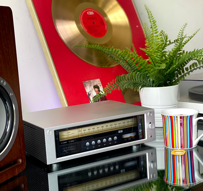 Rose RS-201E Streamer, DAC and amplifier showing the radio display with a plant and mug beside it