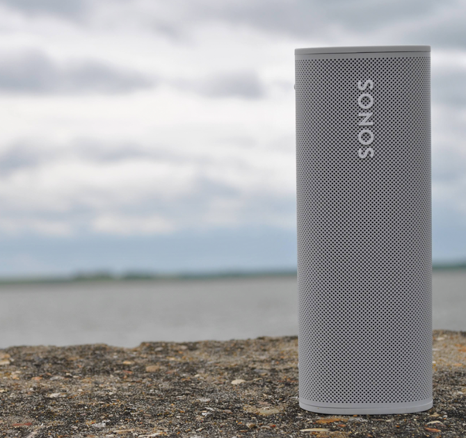 SONOS Roam in white standing up on the sea wall