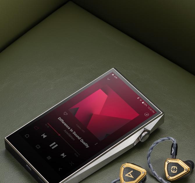 Astell & Kern SP3000T Portable Music Player laying on a sofa with some earphones beside it