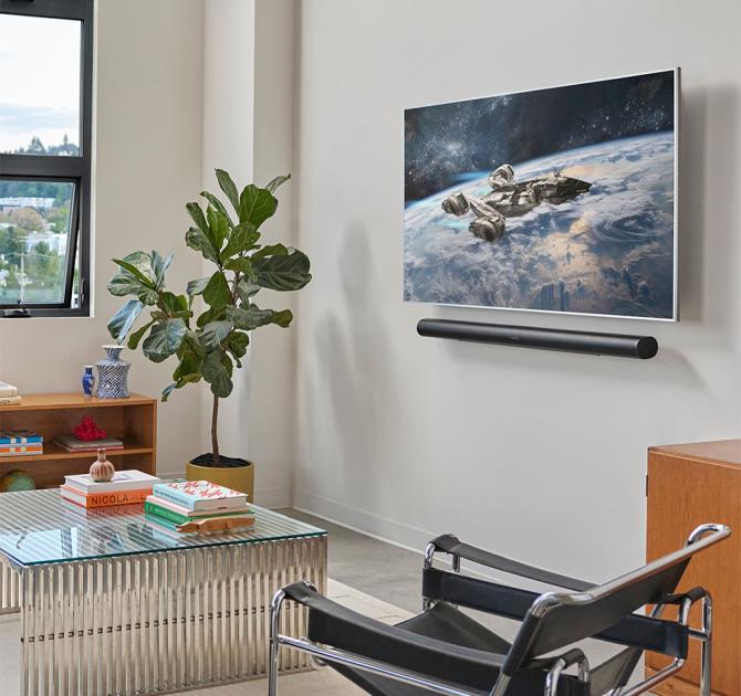 SONOS Arc Ultra Smart Soundbar in black on a wall underneath a tv screen