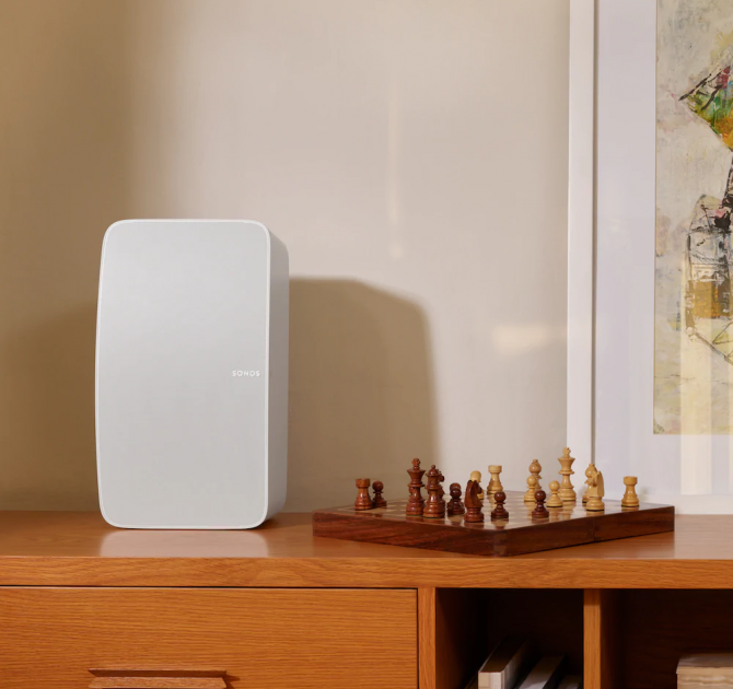 SONOS Five in white on a cabinet with a chess set beside it.