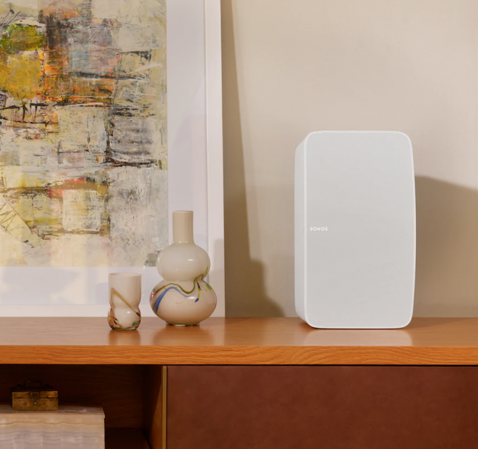 SONOS Five in white on a cabinet beside a vase