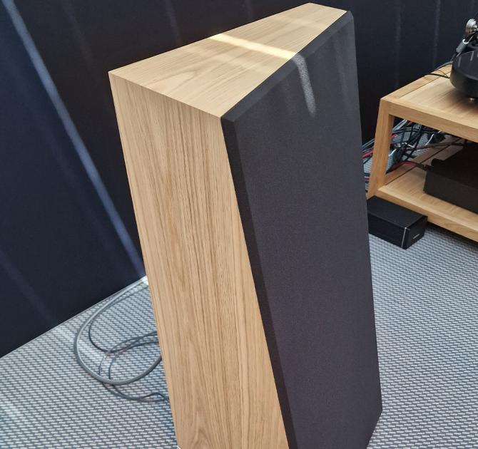 Audiovector Trapeze Ri in oak with the grille in place viewed from the side