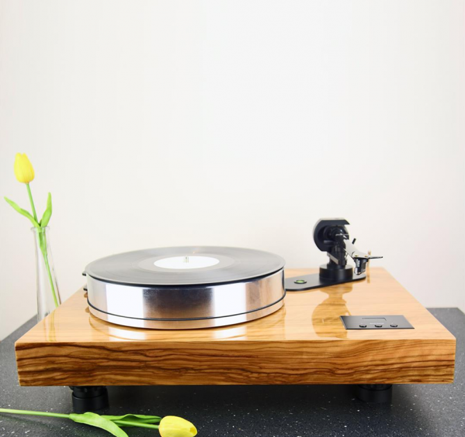 Project Xtension 12 (no cartridge) on a work surface with one yellow tulip in a vase and one laying in front of the turntable.