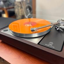 Linn Sondek LP12-50 Turntable with an orange record playing on it