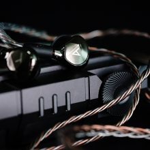 Astell & Kern AKT9iE Earphones Black with an Astell & Kern player close-up.