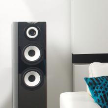Cabasse Java MC40 Loudspeaker in black beside a white sofa