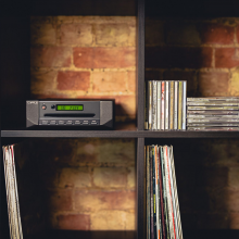 Cyrus CD i Integrated CD Player and DAC in a modular shelving unit with records and CDs.