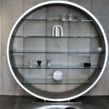 Cabasse Pearl Keshi Loudspeaker System in white on a modern circular shelf unit