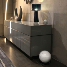 Cabasse Pearl Keshi Loudspeaker System in white on a sideboard in a modern living area.