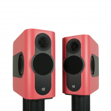 A pair of Kii Three Loudspeakers in a satin salmon colour