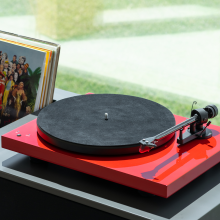 Project Leather-IT 12" leather mat in dark grey on top of a red turntable
