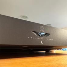 Linn Klimax Twin Amplifier in black - close-up of the front.  The Amp is sitting on a wooden surface in the ripcaster showroom