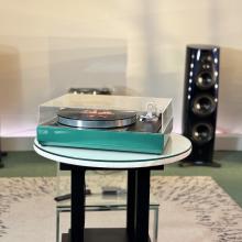 Linn Majik LP12 MC Turntable with custom green plinth with a 360 speaker in the background