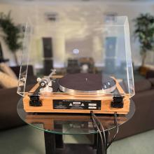 Linn Majik MM LP12 Fluted turntable in oak in the ripcaster showroom with sofas and speakers in the background along with other HiFi equipment