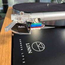 Linn Majik MM LP12 Fluted turntable in oak in the ripcaster showroom with sofas and speakers in the background along with other HiFi equipment