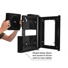 Flexson Wall Mount x4 Amp Black x1 with hands placing the last Sonos Amp in place.  Has the words "Hinged design allows rear access to all four units for easy cabling".