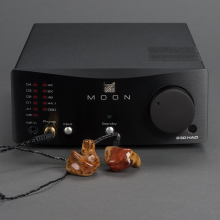 Moon 230HA D Headphone Amplifier with DAC with earphones plugged in.
