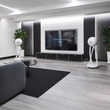 a pair of Cabasse Pearl Pelegrina Loudspeakers in white in a large living area
