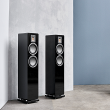 Audiovector QR3 pair in piano black against a grey wall
