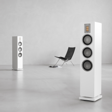 Audiovector QR5 pair in white with a chair.