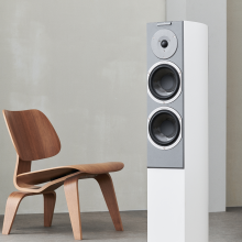 Audiovector R3 Signature in white next to a chair