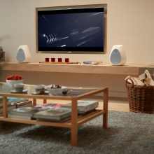 Linn Series 3 301 and 302 either side of a wall-mounted television with a coffee table in the foreground.