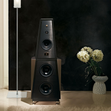 Rosso Fiorentino Siena 2 Loudspeaker in a living area with a vase of flowers on the floor to the right of the image.