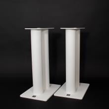 A pair of Kii speaker stands in white against a black background