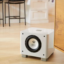 REL T/7x Sub-woofer in white on the floor in a kitchen