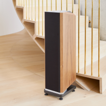 Kudos Titan 606 speaker with grill on at the side of a staircase.