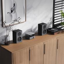 WiiM Vibelink Amp on a side unit with speakers either side