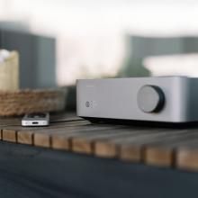 WiiM Vibelink Amp on a wooden shelf