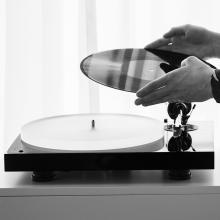 Project X1 B Turntable hands putting a record on